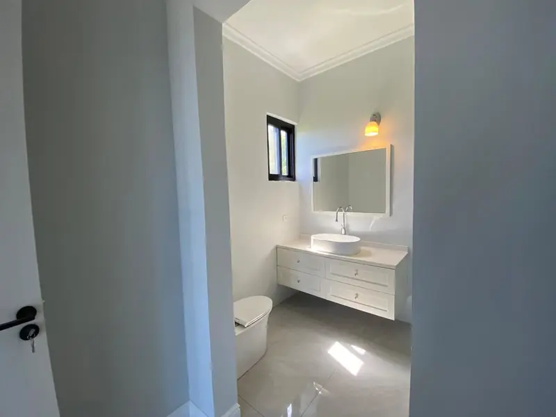 Bathroom with a floating vanity and backlit mirror