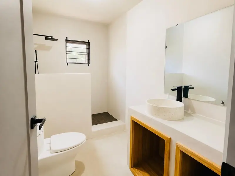 Bathroom with a vessel sink on timber shelving and a walk-in shower