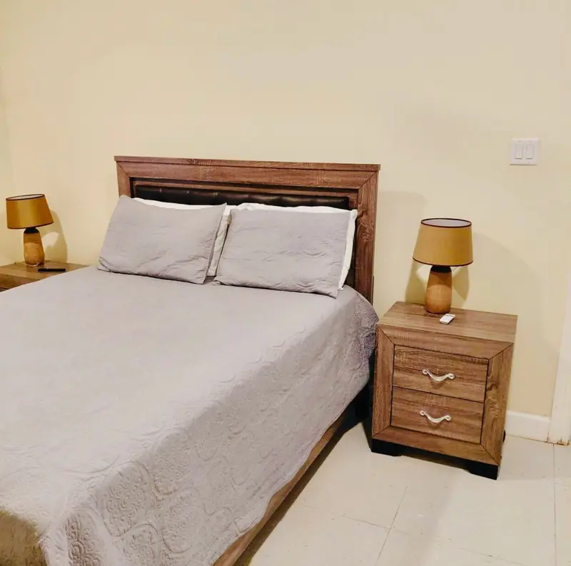 Bedroom with a timber headboard and two bedside lamps