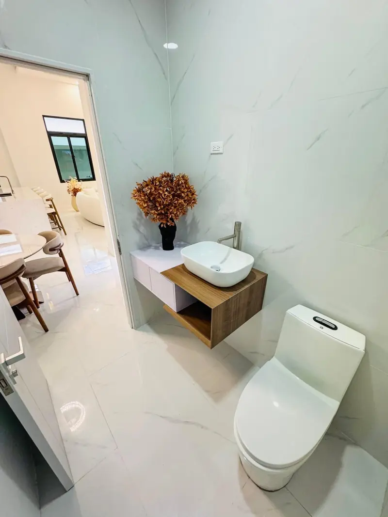 Powder room with a vessel sink on a timber shelf